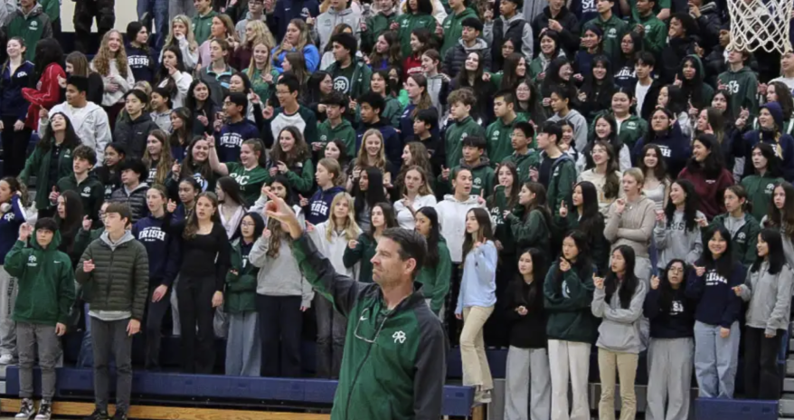 Freshmen reciting the Alma Mater behind the school principal, Dr. Cannon, at the winter rally.
